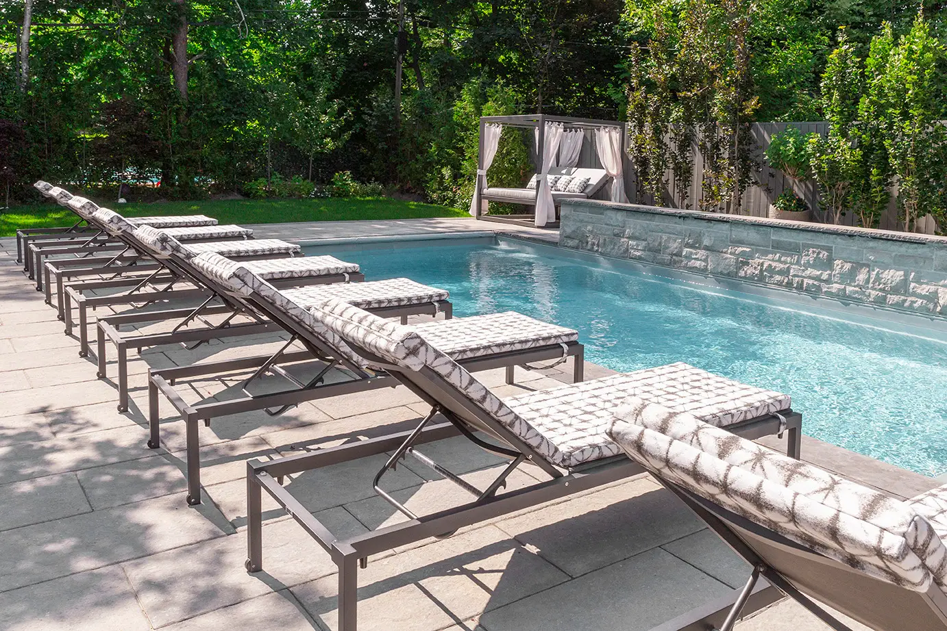 Outdoor lounge furniture with plush cushions and accent tables, styled for relaxed entertaining.